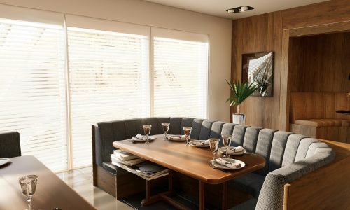 A serene and cozy dining room with minimalist decor, featuring wooden elements and soft lighting.